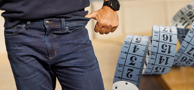 Nahaufnahme von einem Mann in einer Hose mit Maßband daneben.