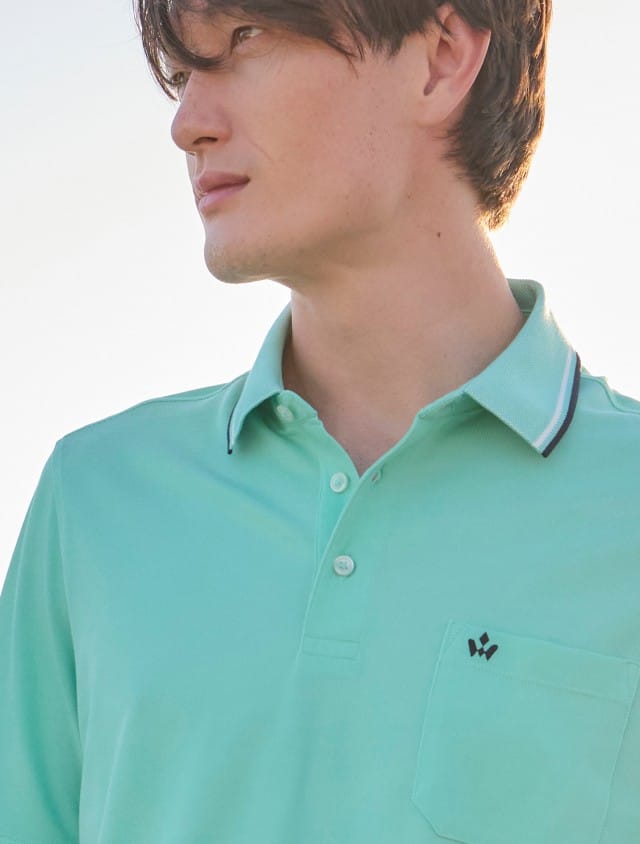 Ein Mann trägt ein Extraglatt-Polo Bicolor in Uni Mint.